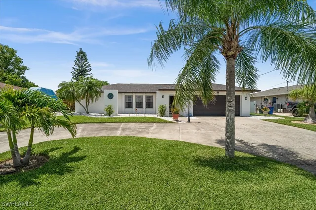 a front view of house with yard and green space