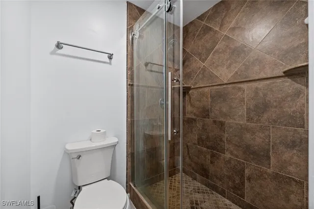 a bathroom with a toilet and a shower