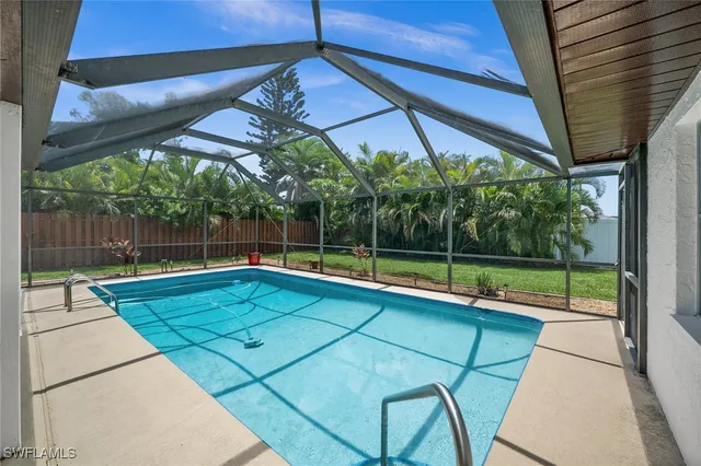 a view of a backyard with a swimming pool