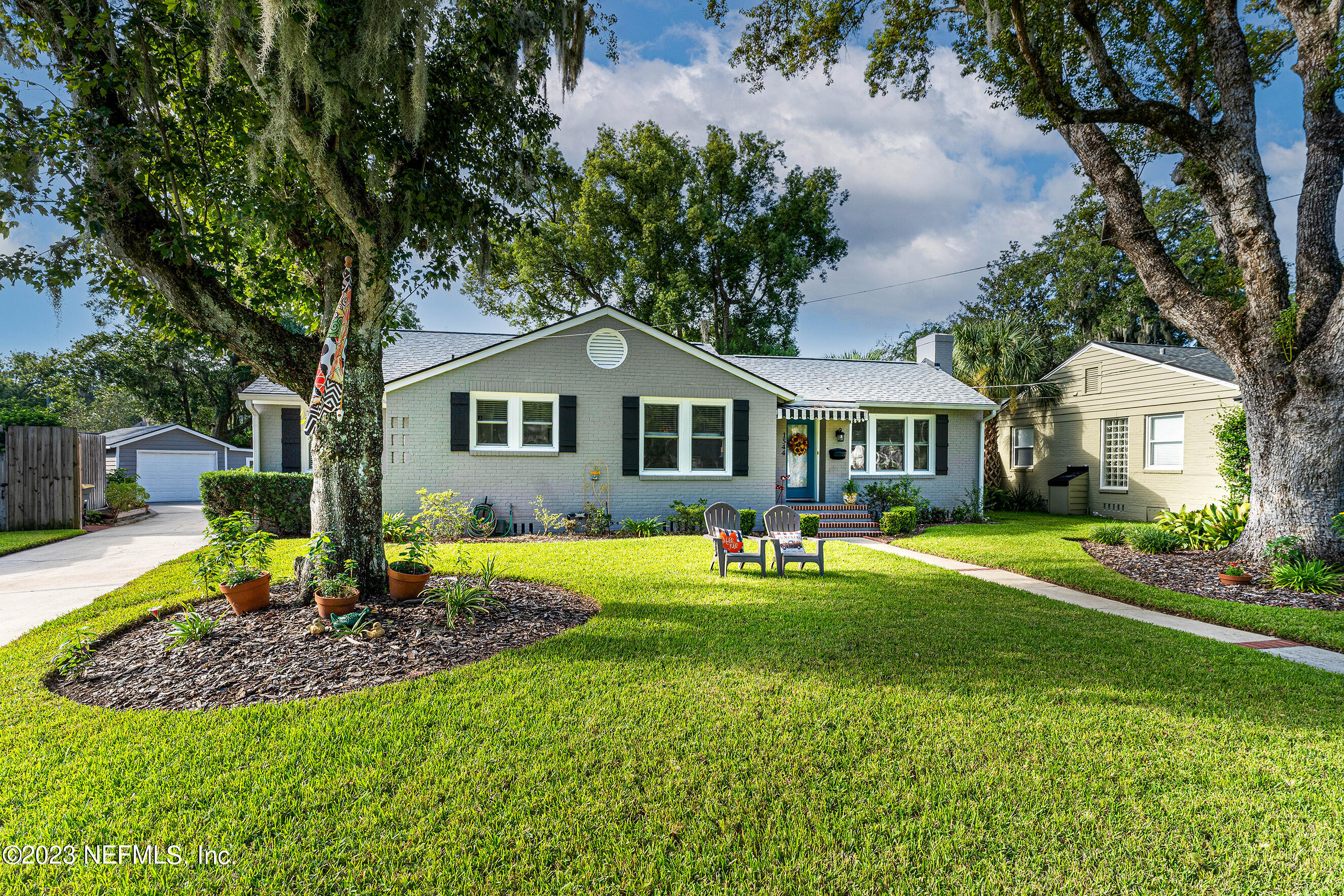 1544 Lorimier Road Jacksonville, FL 32207 - Photo 1 of 27 a front view of a house with a yard table and chairs