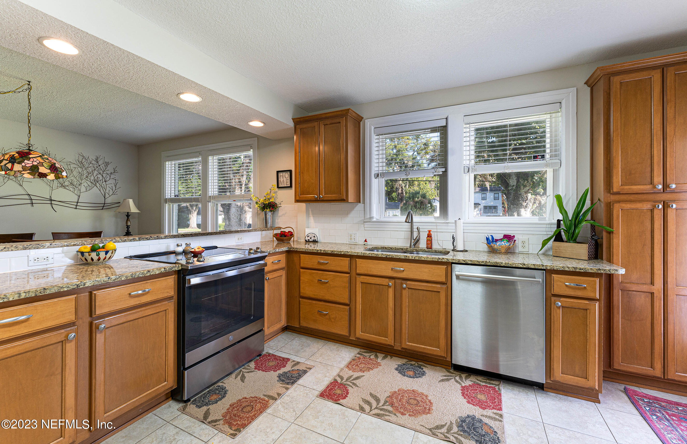 1544 Lorimier Road Jacksonville, FL 32207 - Photo 11 of 27 a kitchen with stainless steel appliances granite countertop a sink stove and refrigerator
