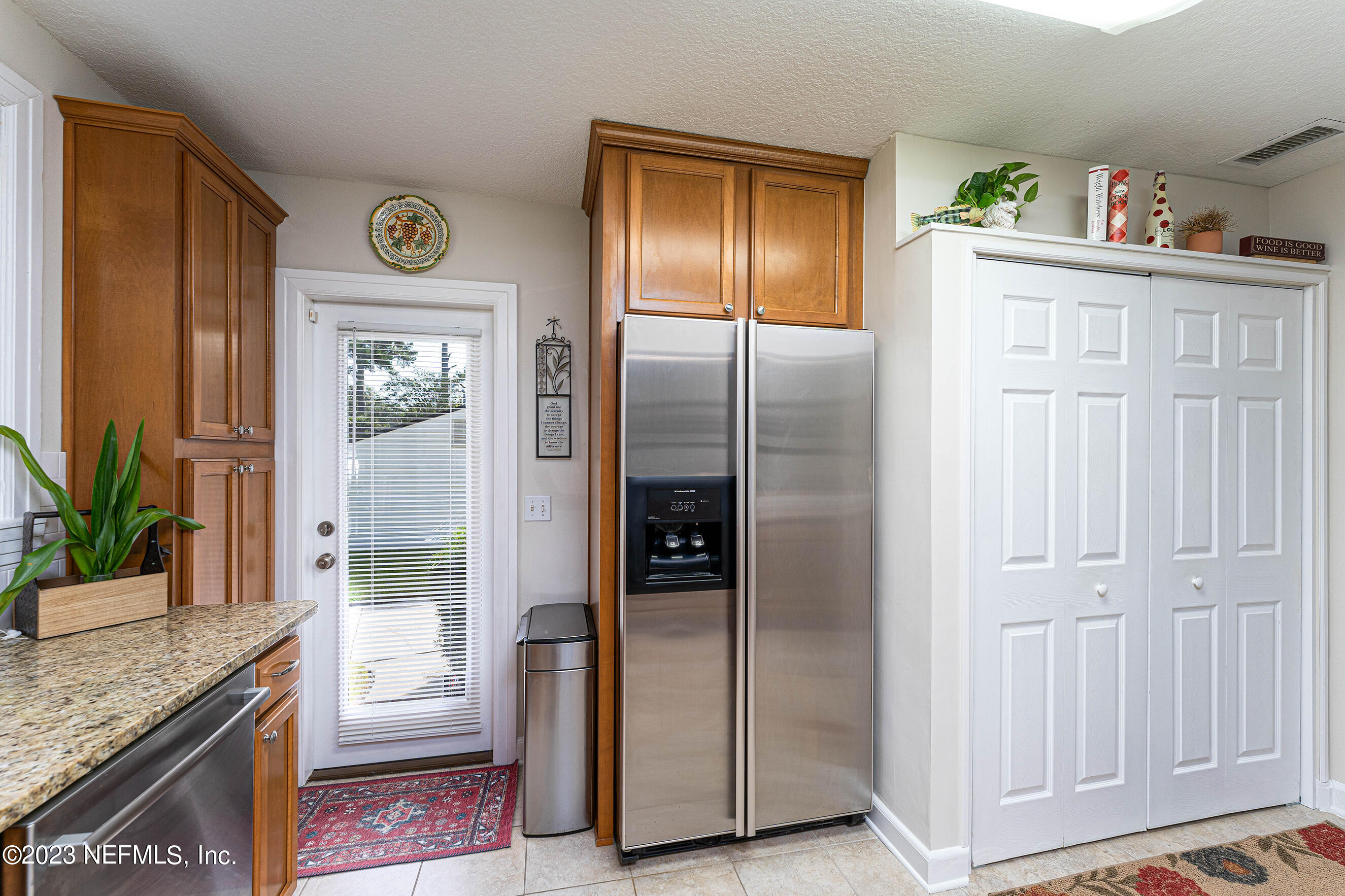 1544 Lorimier Road Jacksonville, FL 32207 - Photo 12 of 27 a kitchen with stainless steel appliances granite countertop a refrigerator and a stove top oven