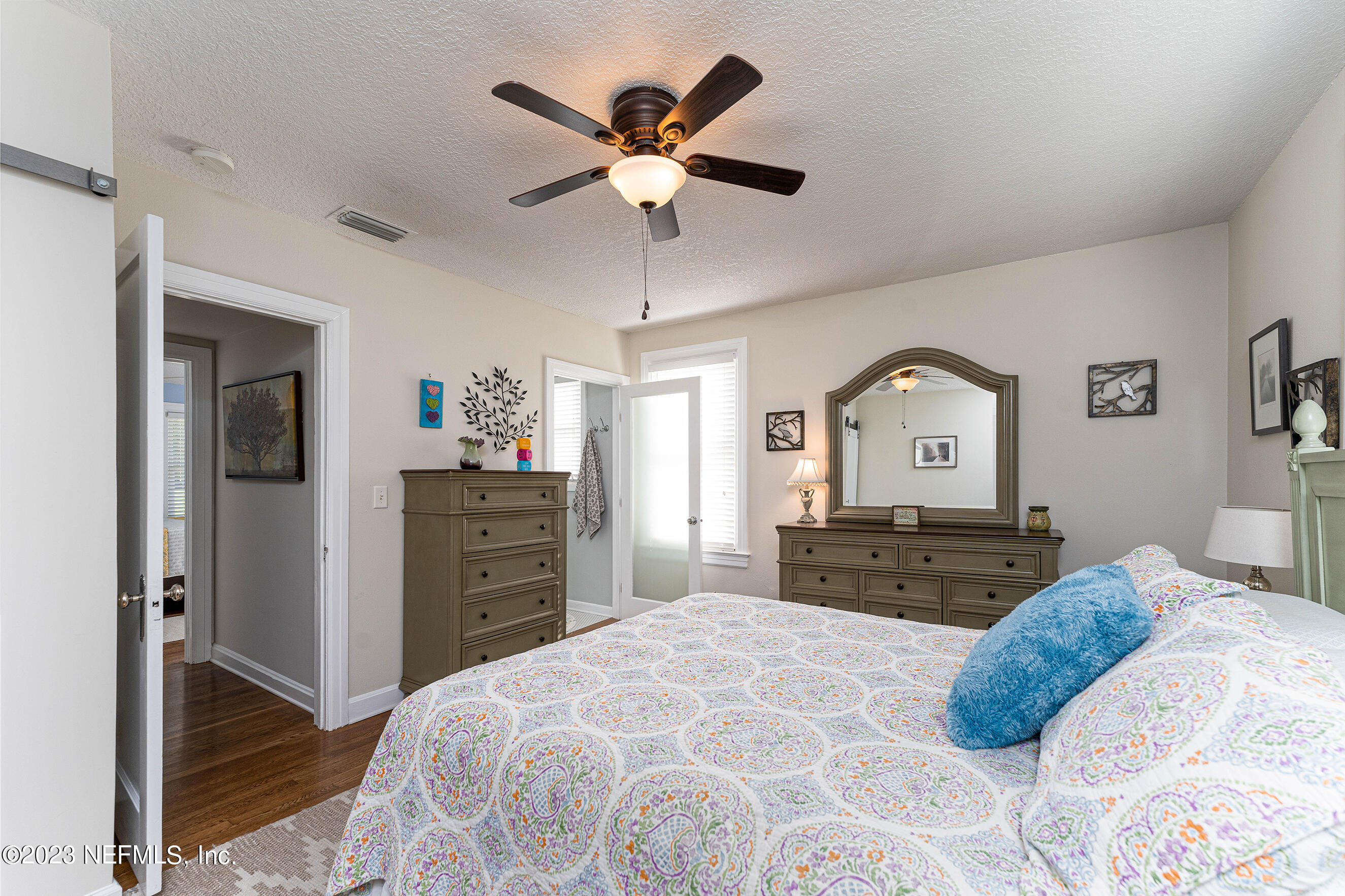 1544 Lorimier Road Jacksonville, FL 32207 - Photo 14 of 27 a bedroom with a bed and a dresser with mirror