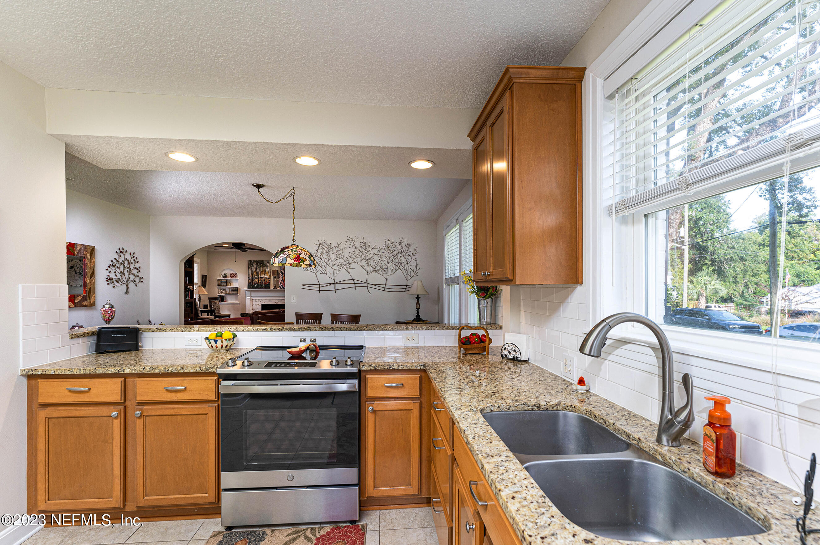 1544 Lorimier Road Jacksonville, FL 32207 - Photo 10 of 27 a kitchen with stainless steel appliances granite countertop a sink stove and cabinets