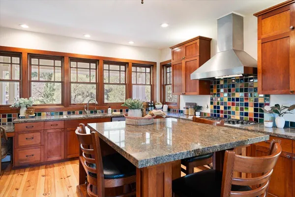 a kitchen that has a table chairs and refrigerator