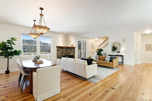 a living room with furniture wooden floor and a fireplace