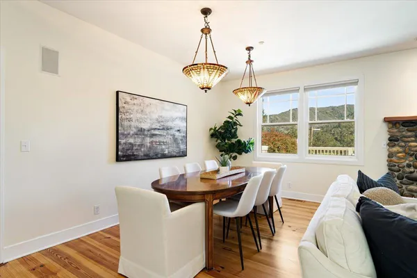 a view of a dining room with furniture window and wooden floor