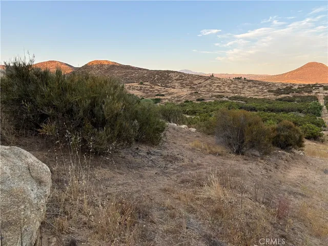 a view of a mountain in the distance in a field
