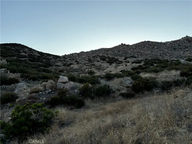 a view of a mountain in the distance in a field