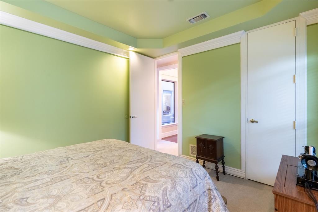 1450 Meandering Way Rockwall, TX 75087 - Photo 23 of 32 a bedroom with a bed a table and a chair