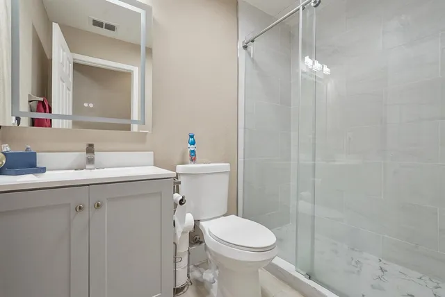 a bathroom with a sink toilet and shower