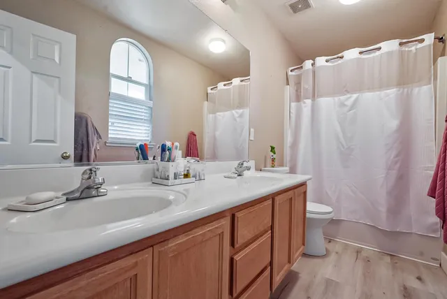 a bathroom with a double vanity sink and a mirror