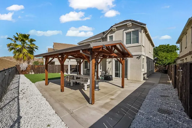 a patio with table and chairs
