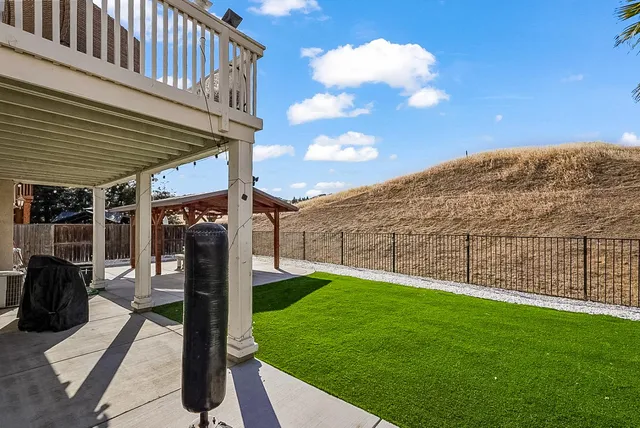 a view of a backyard with sitting area