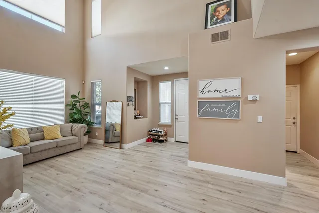 a living room with furniture and wooden floor