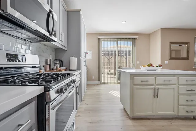a kitchen with stainless steel appliances granite countertop a stove and a sink