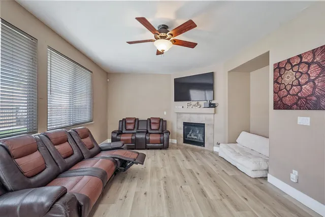 a living room with furniture fireplace and flat screen tv
