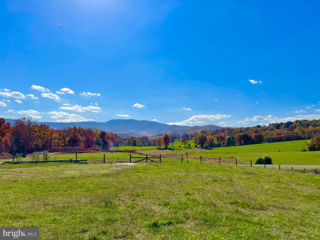 a view of grassy field with mountain