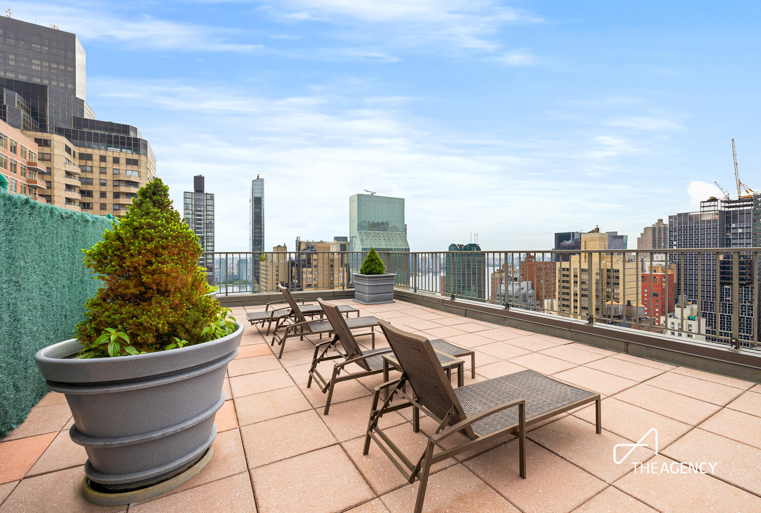 212 East 47th Street, Unit 34C Manhattan, NY 10017 - Photo 8 of 9 a view of a terrace with chairs and a potted plant
