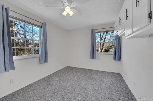 an empty room with windows and entrance