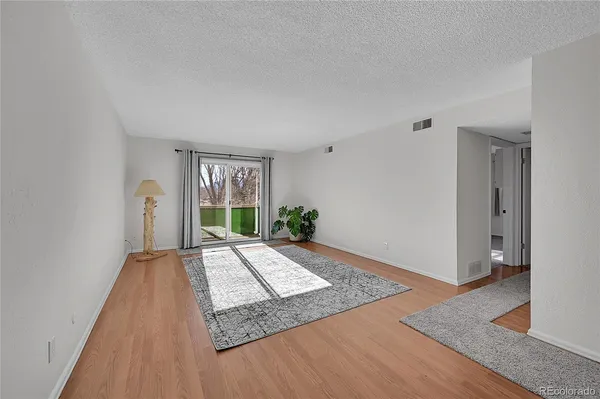 a view of a bedroom with wooden floor and windows