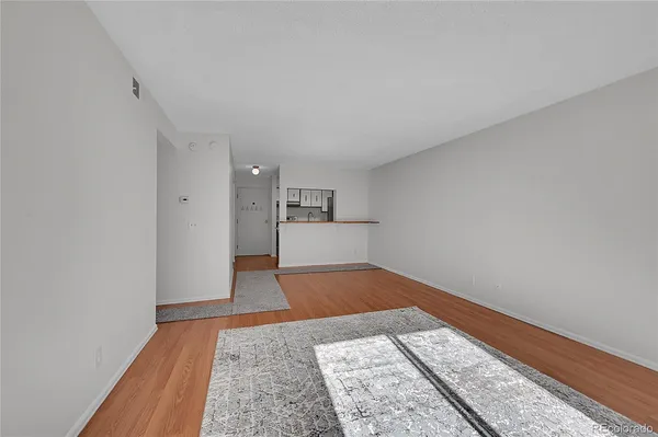 a view of kitchen and hall with wooden floor
