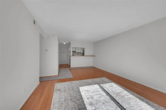 a view of kitchen and hall with wooden floor