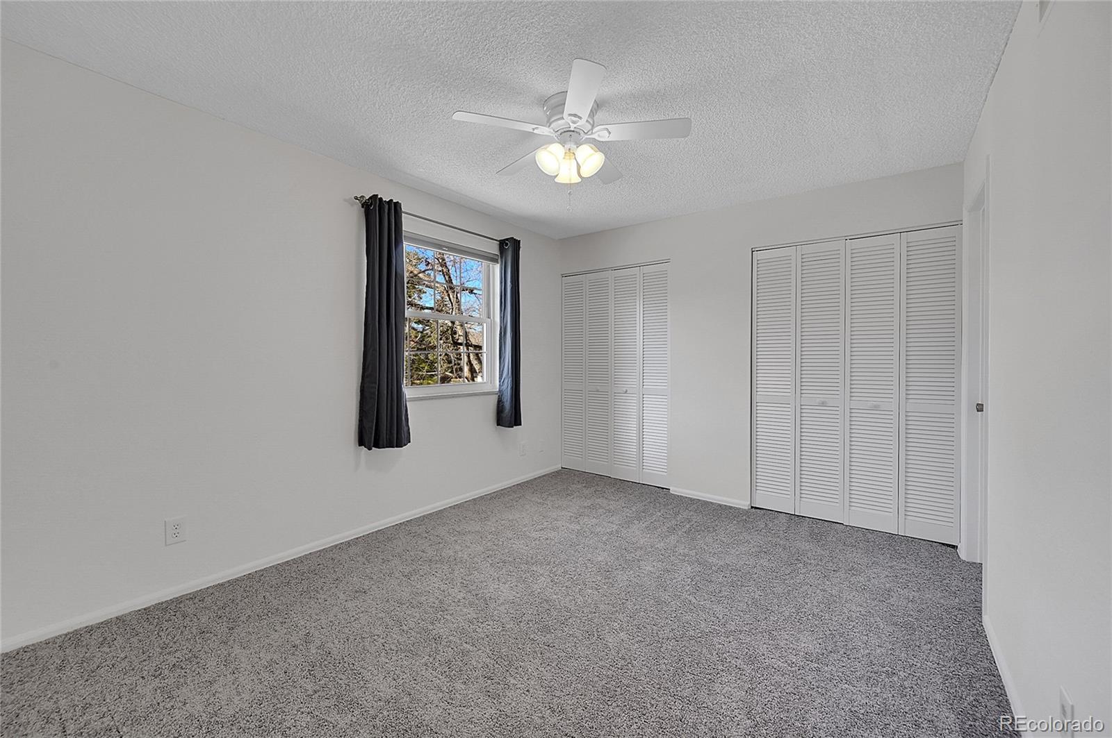 3250 Oneal Circle, Unit 25J Boulder, CO 80301 - Photo 7 of 22 an empty room with windows and fan
