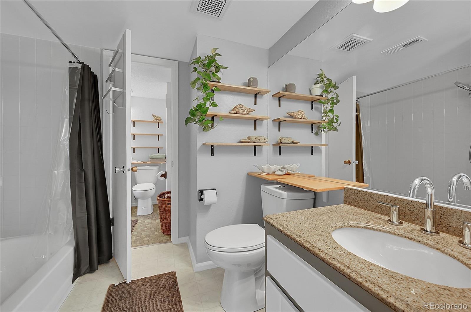 3250 Oneal Circle, Unit 25J Boulder, CO 80301 - Photo 10 of 22 a bathroom with a granite countertop toilet sink and shower