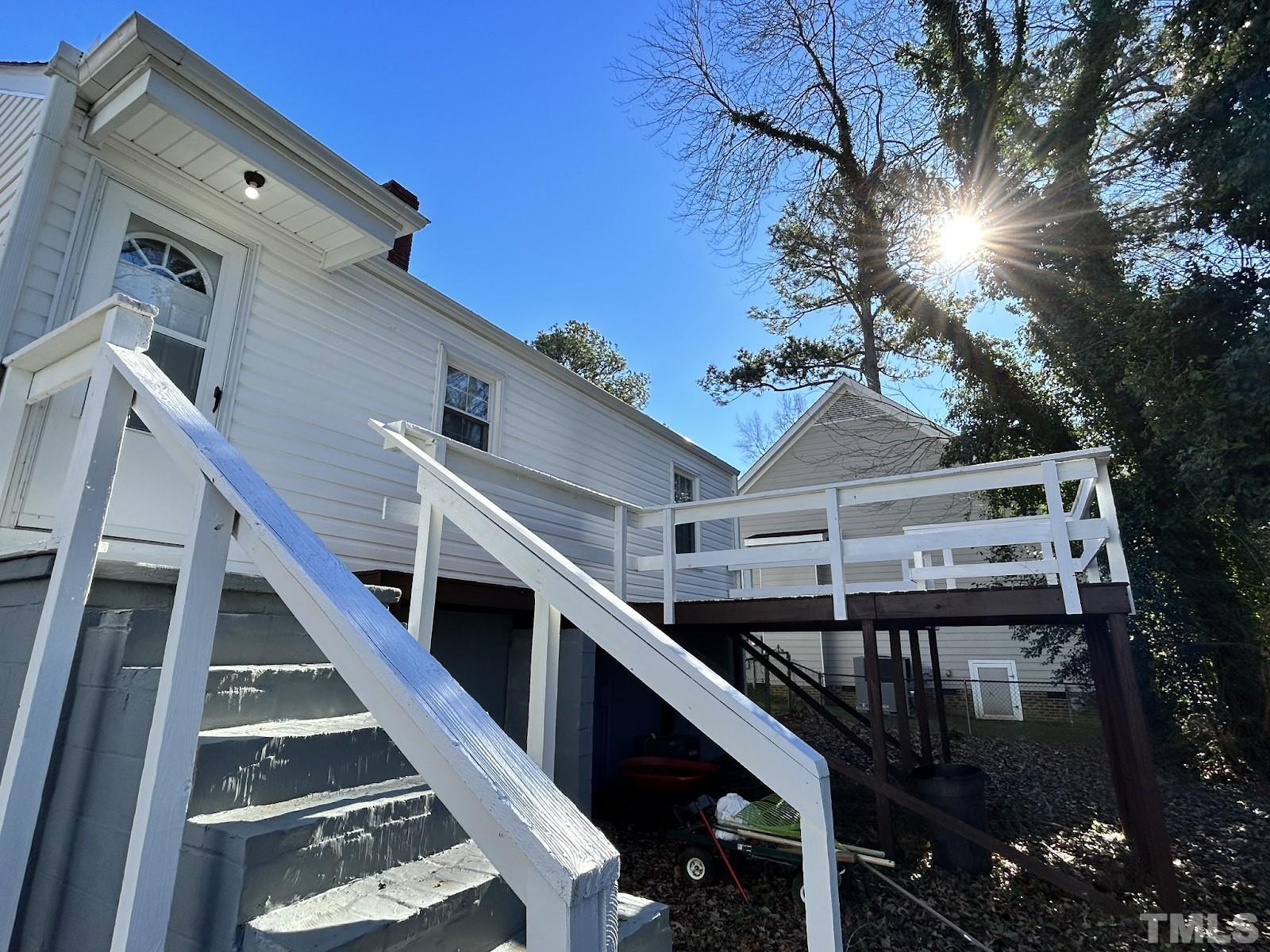 1717 Bennett Street Raleigh, NC 27604 - Photo 2 of 15 a balcony of a house with wooden floor and stairs