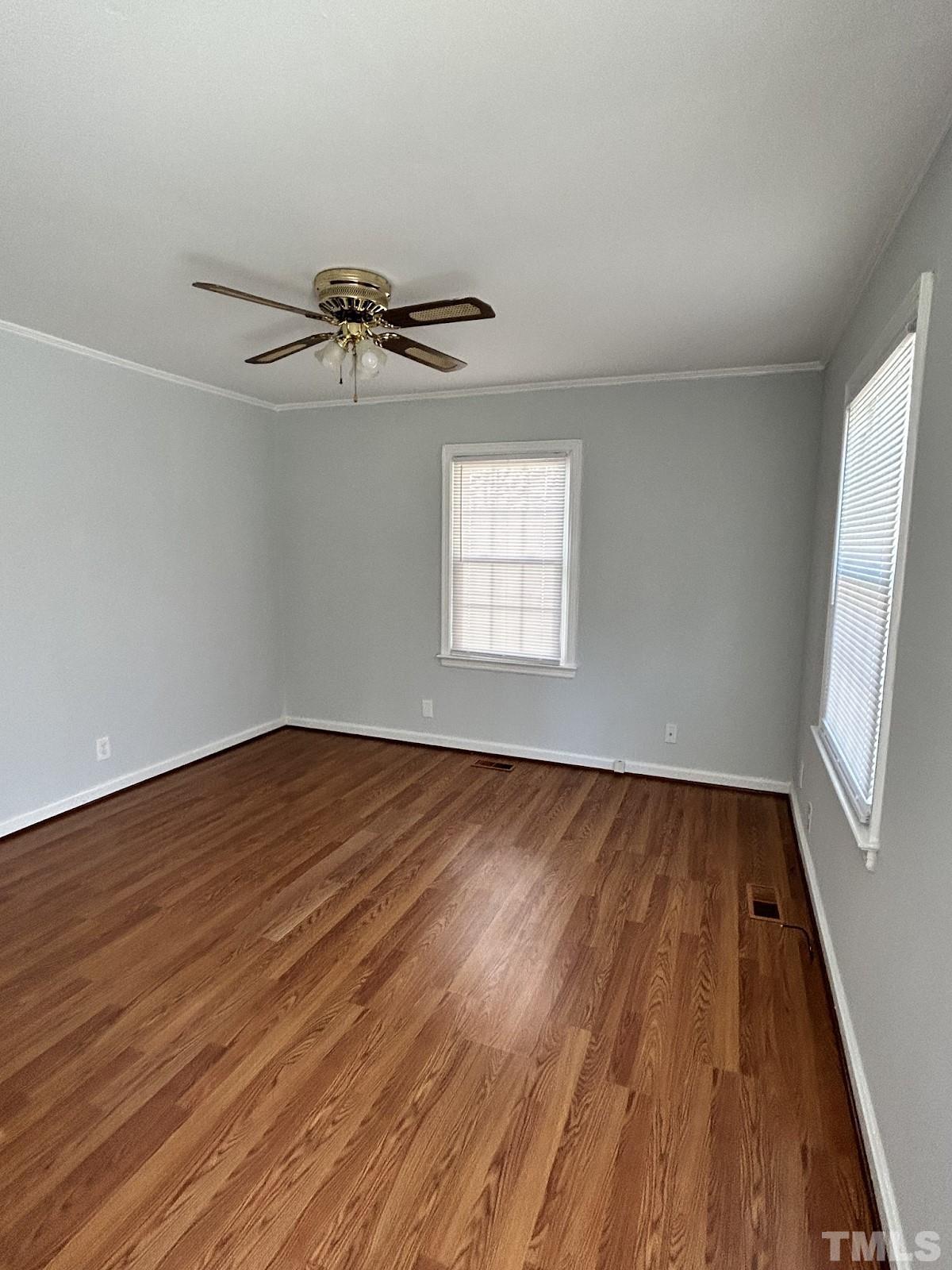 1717 Bennett Street Raleigh, NC 27604 - Photo 4 of 15 wooden floor in an empty room with a window