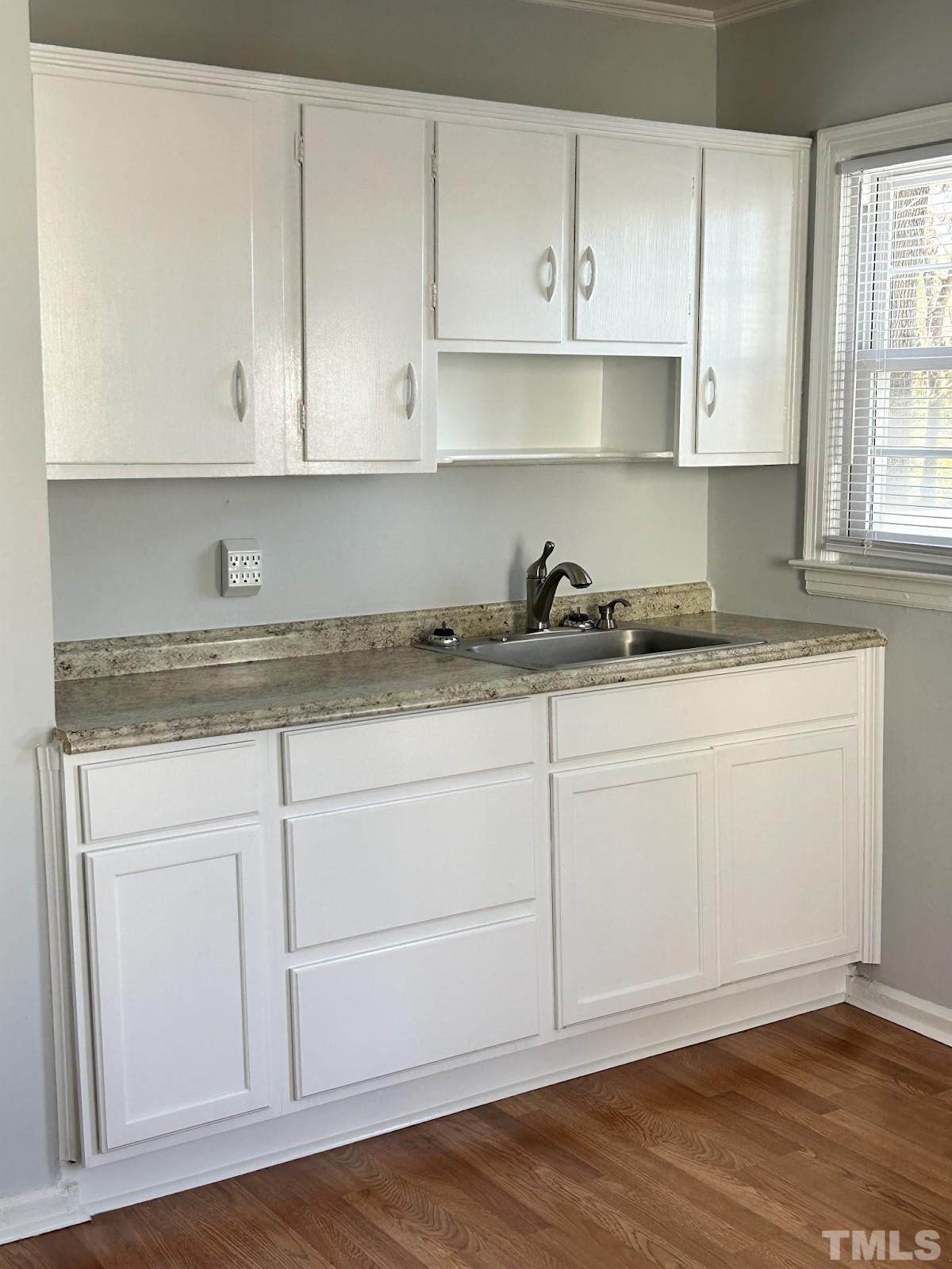 1717 Bennett Street Raleigh, NC 27604 - Photo 5 of 15 a kitchen with granite countertop white cabinets and a sink