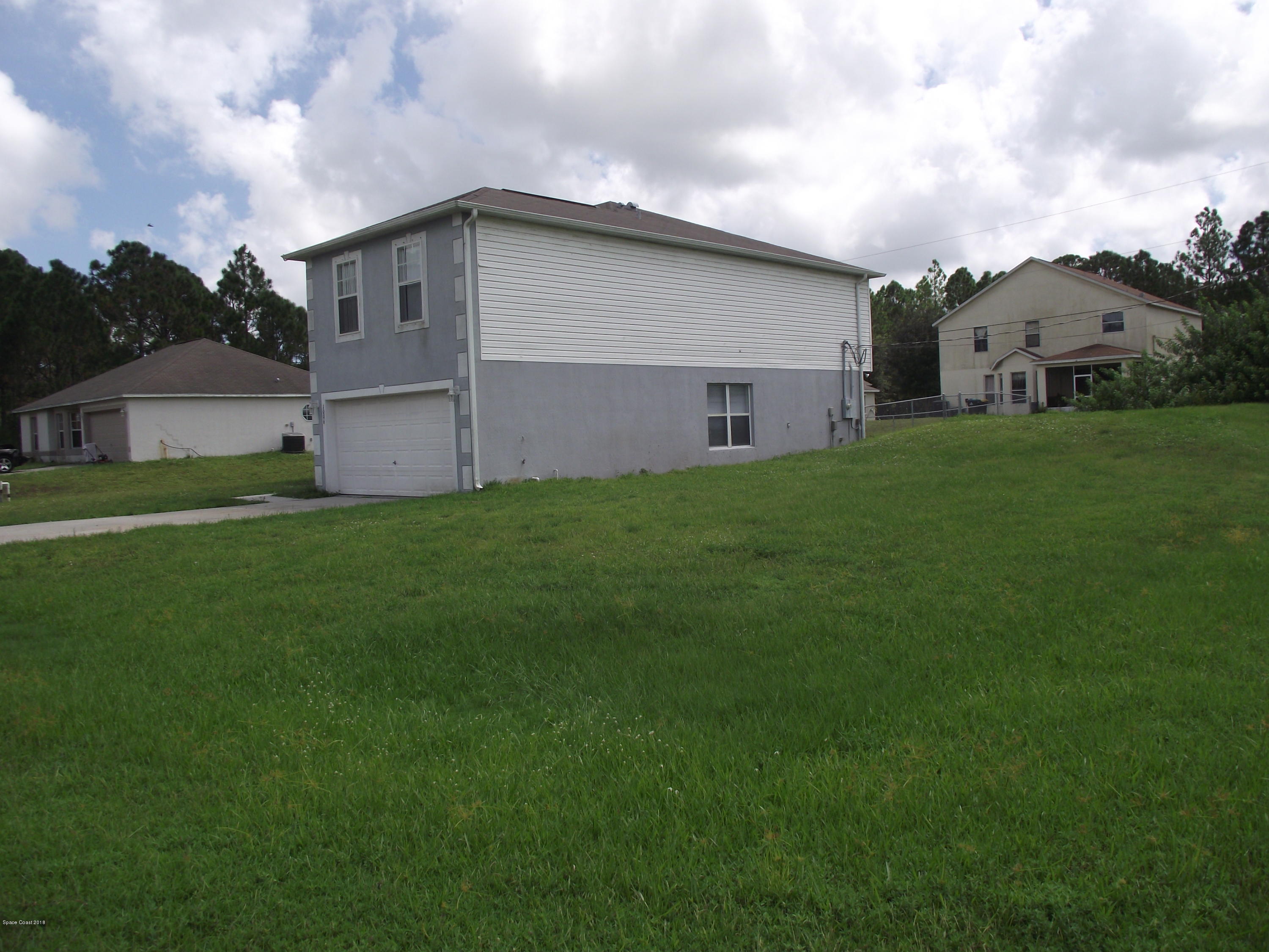 1006 Ray Road Southeast Palm Bay, FL 32909 - Photo 2 of 21 a view of a back yard of the house