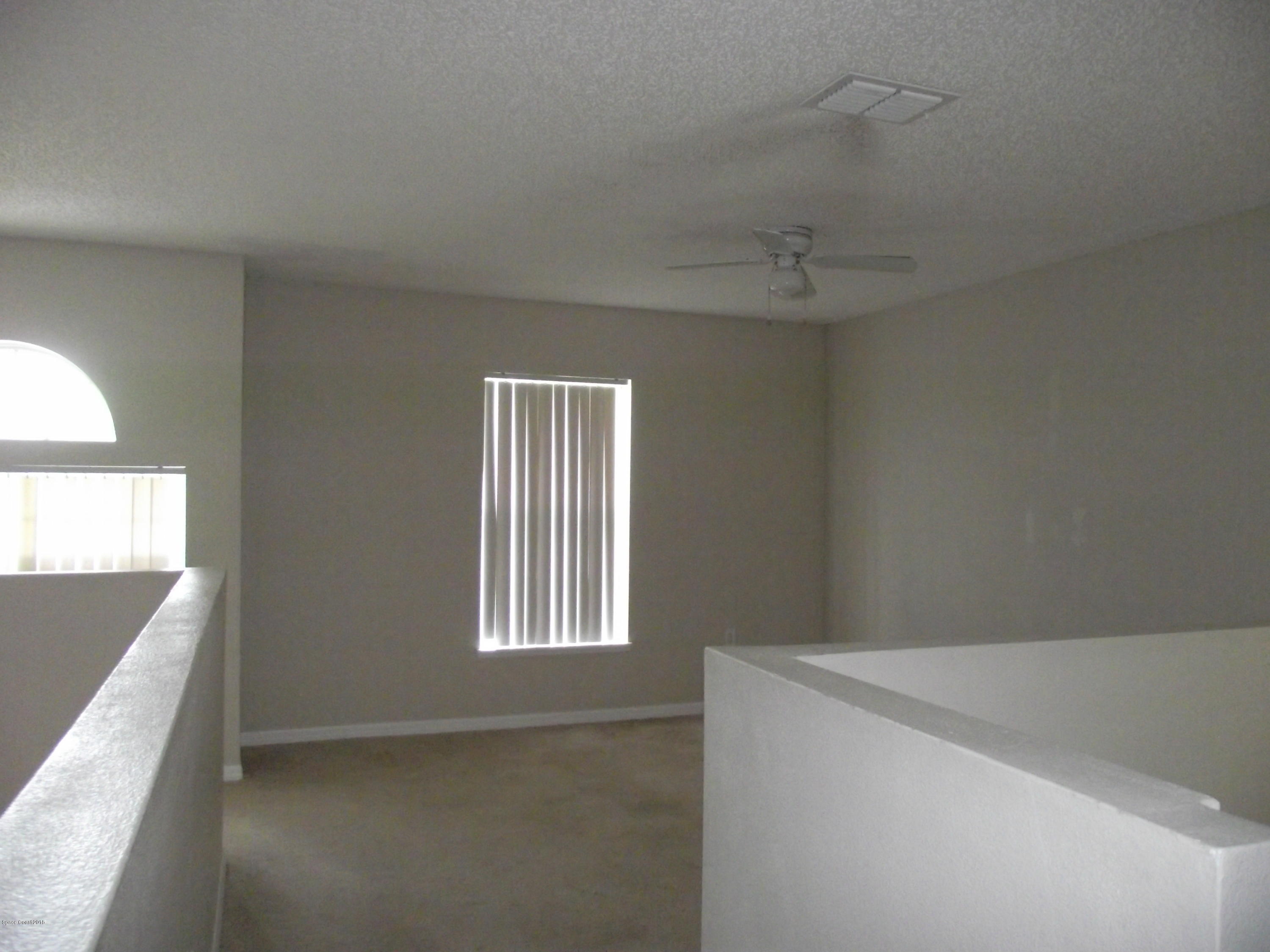 1006 Ray Road Southeast Palm Bay, FL 32909 - Photo 12 of 21 a view of an empty room with a window