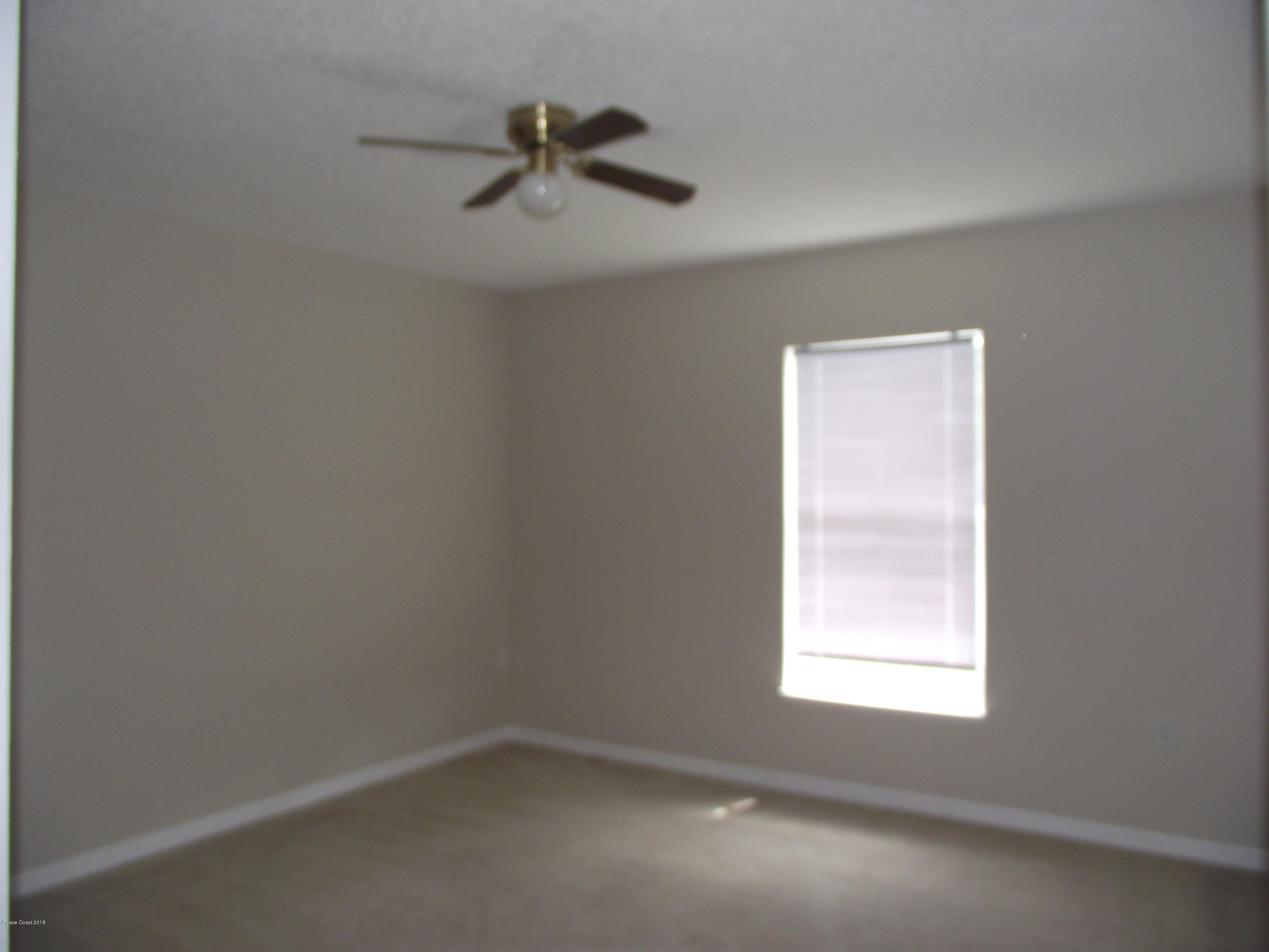 1006 Ray Road Southeast Palm Bay, FL 32909 - Photo 15 of 21 an empty room with a window