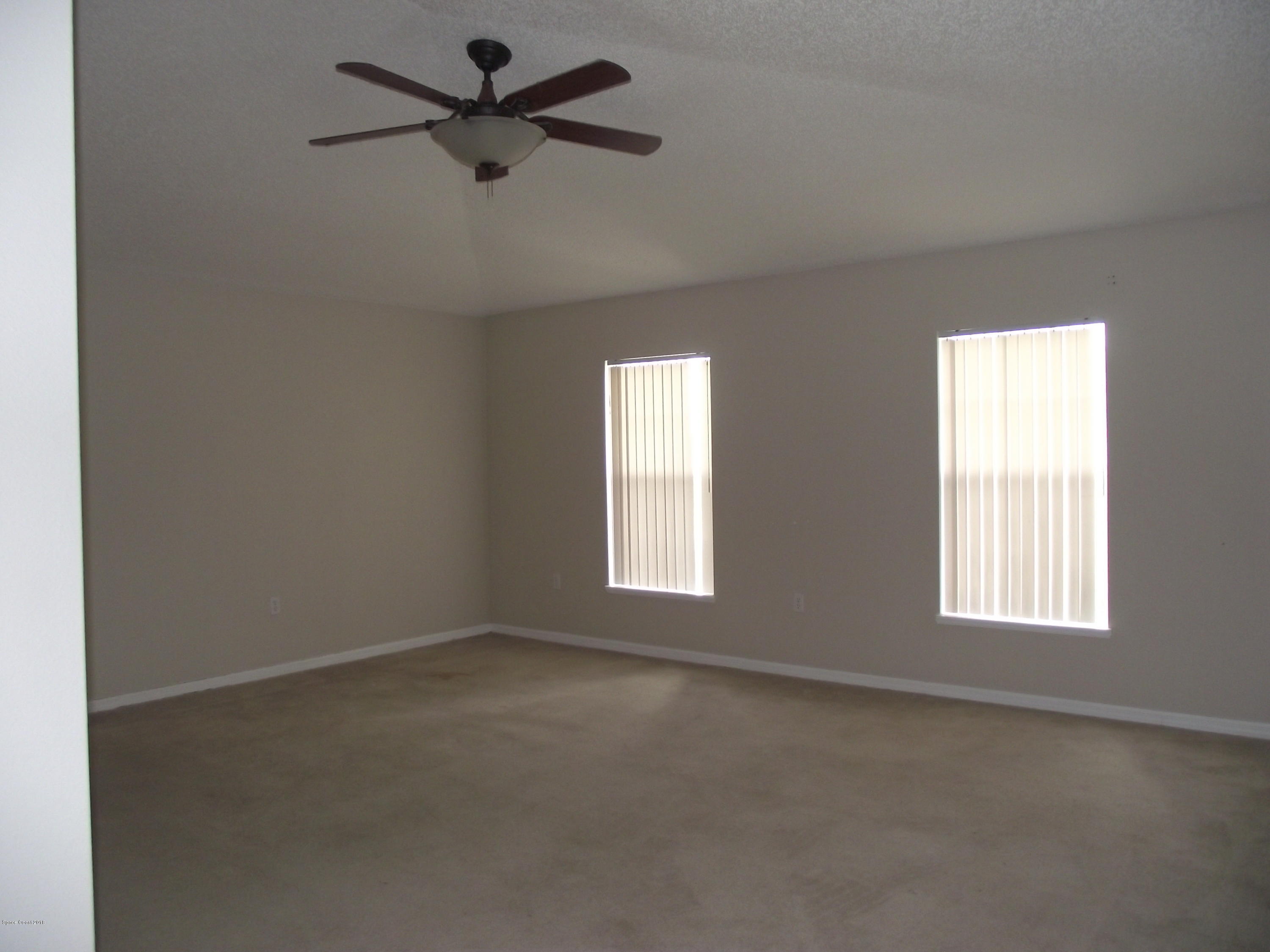 1006 Ray Road Southeast Palm Bay, FL 32909 - Photo 17 of 21 an empty room with a window and a fan