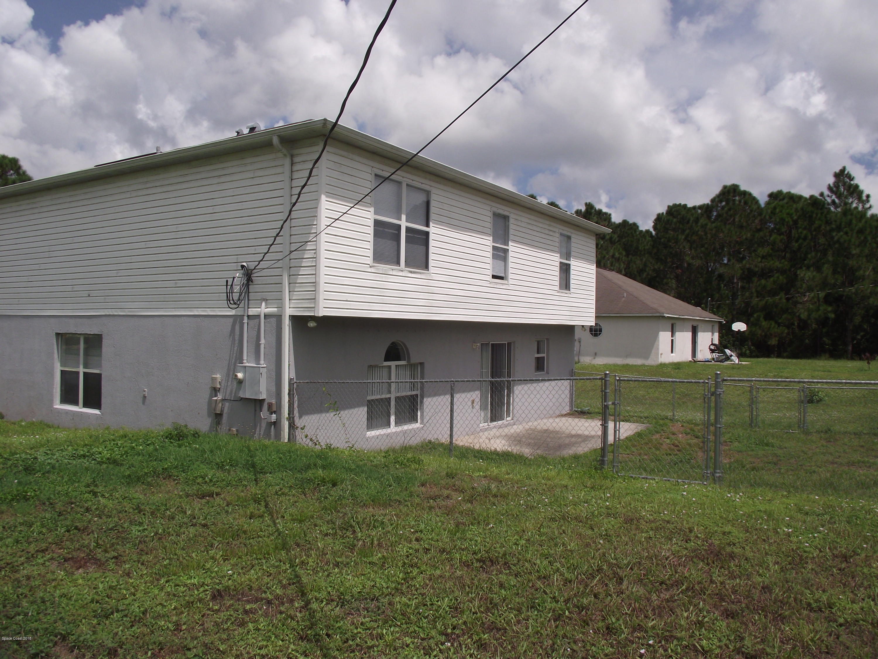 1006 Ray Road Southeast Palm Bay, FL 32909 - Photo 20 of 21 a front view of a house with garden