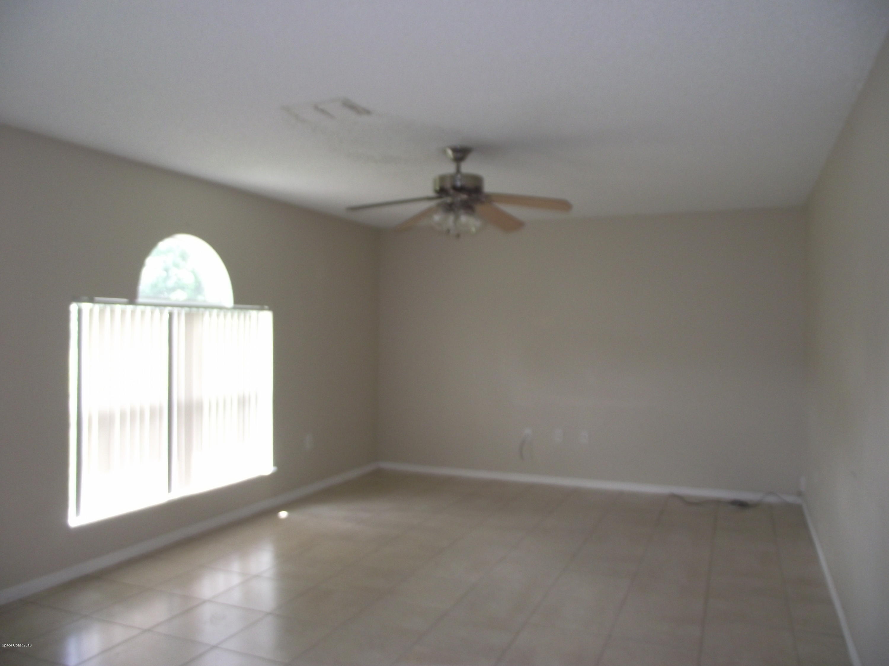 1006 Ray Road Southeast Palm Bay, FL 32909 - Photo 5 of 21 an empty room with a window