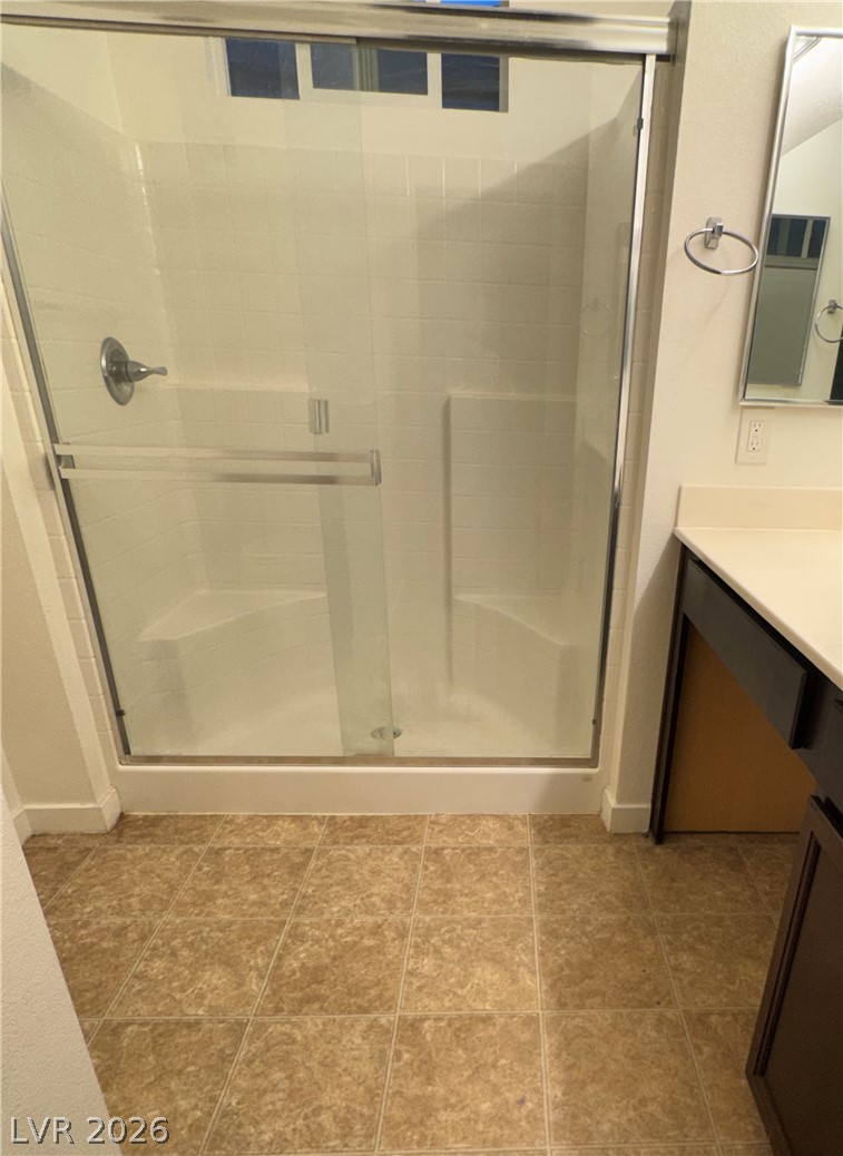 1892 Via Del Rey Court Las Vegas, NV 89115 - Photo 10 of 10 A streamlined shower enclosure with tiled walls and glass doors creates a clean bathroom experience.