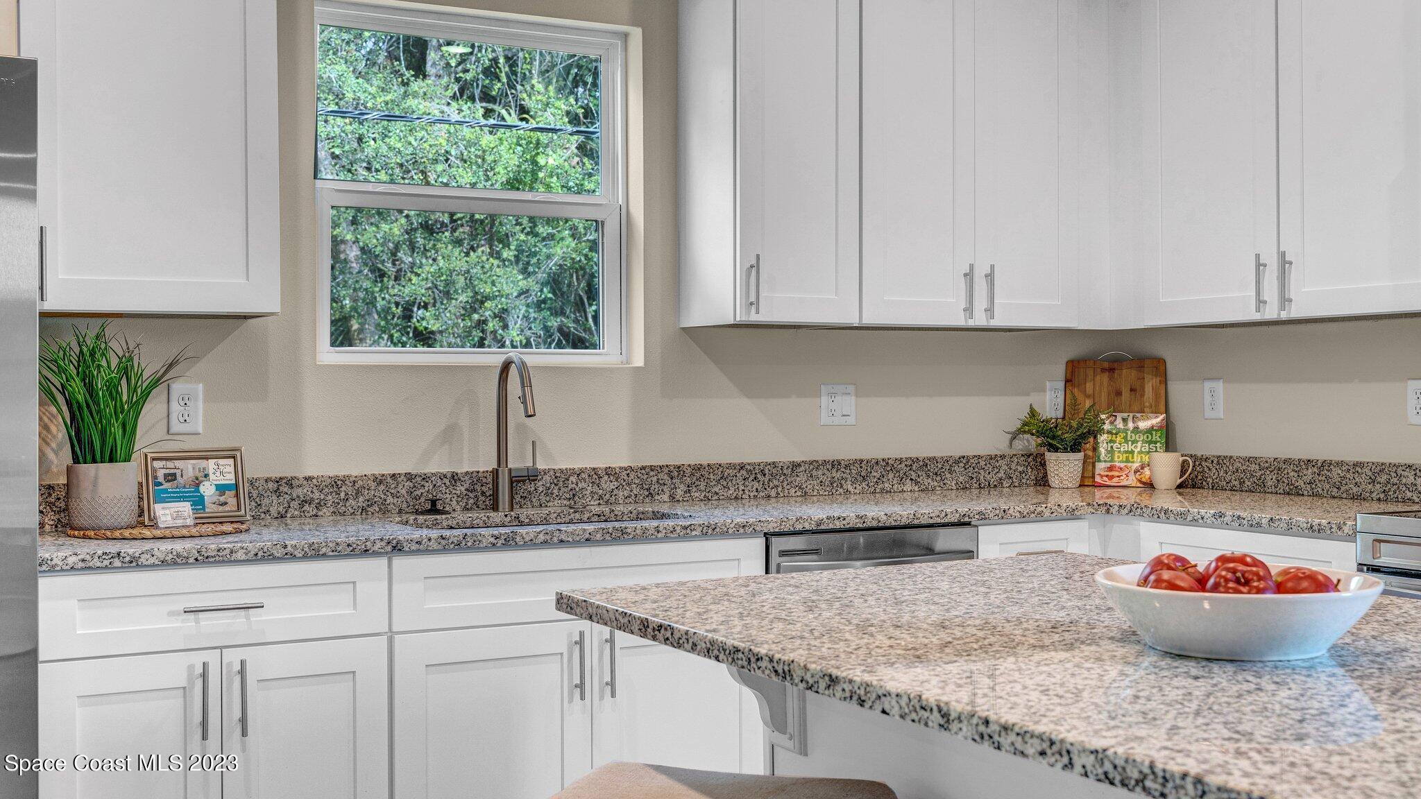 491 Tilhal Road Southwest Palm Bay, FL 32908 - Photo 10 of 30 a kitchen with a sink and cabinets