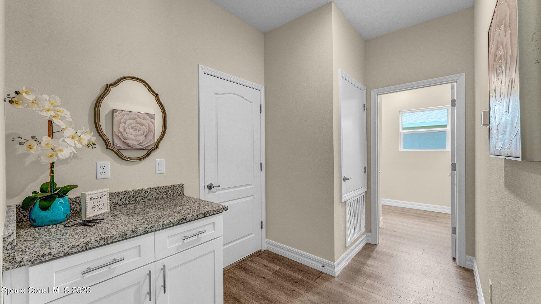 491 Tilhal Road Southwest Palm Bay, FL 32908 - Photo 12 of 30 a bathroom with a granite countertop sink and a mirror