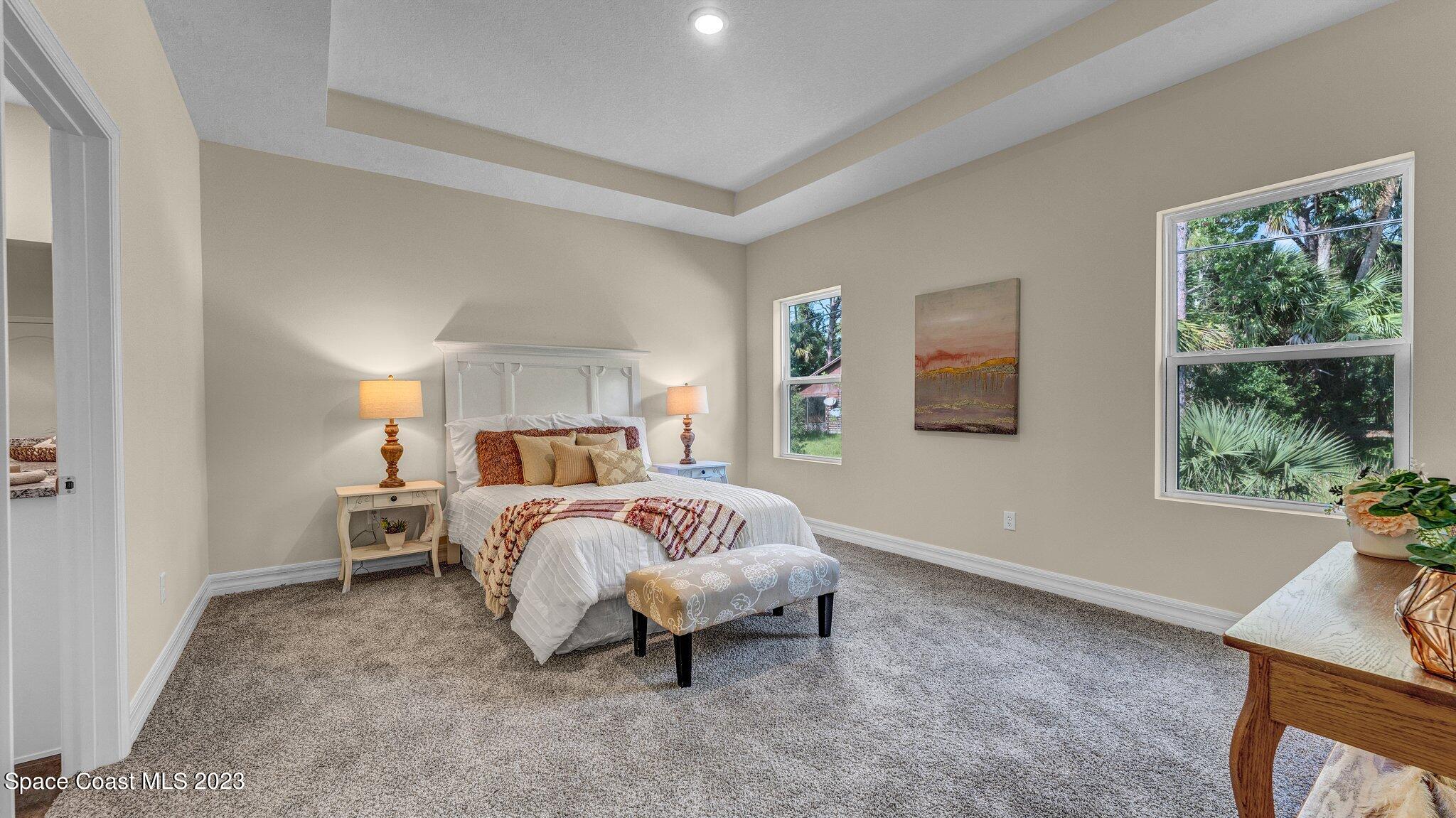 491 Tilhal Road Southwest Palm Bay, FL 32908 - Photo 15 of 30 a spacious bedroom with a bed and a window