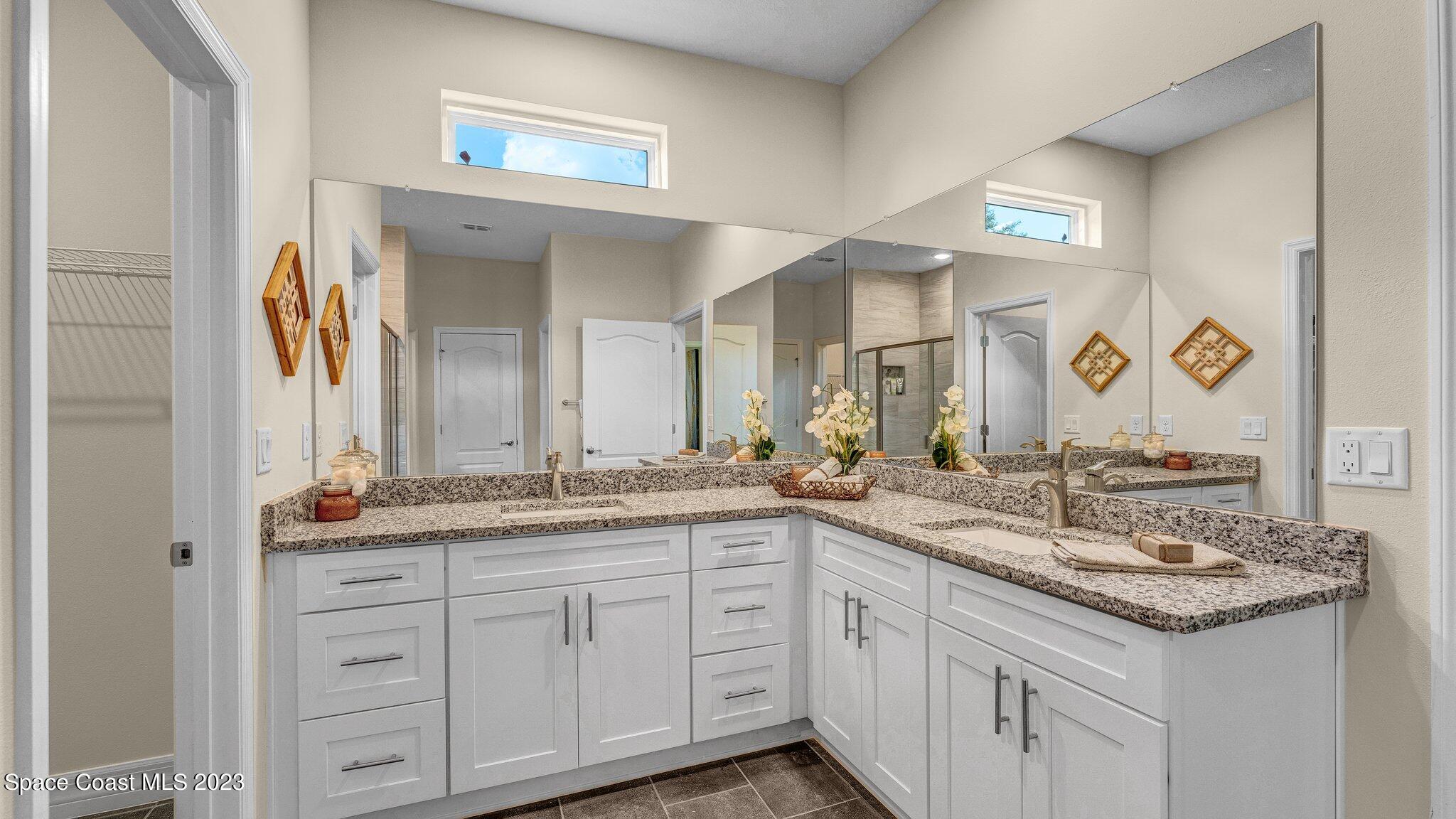 491 Tilhal Road Southwest Palm Bay, FL 32908 - Photo 18 of 30 a bathroom with a granite countertop sink and a mirror