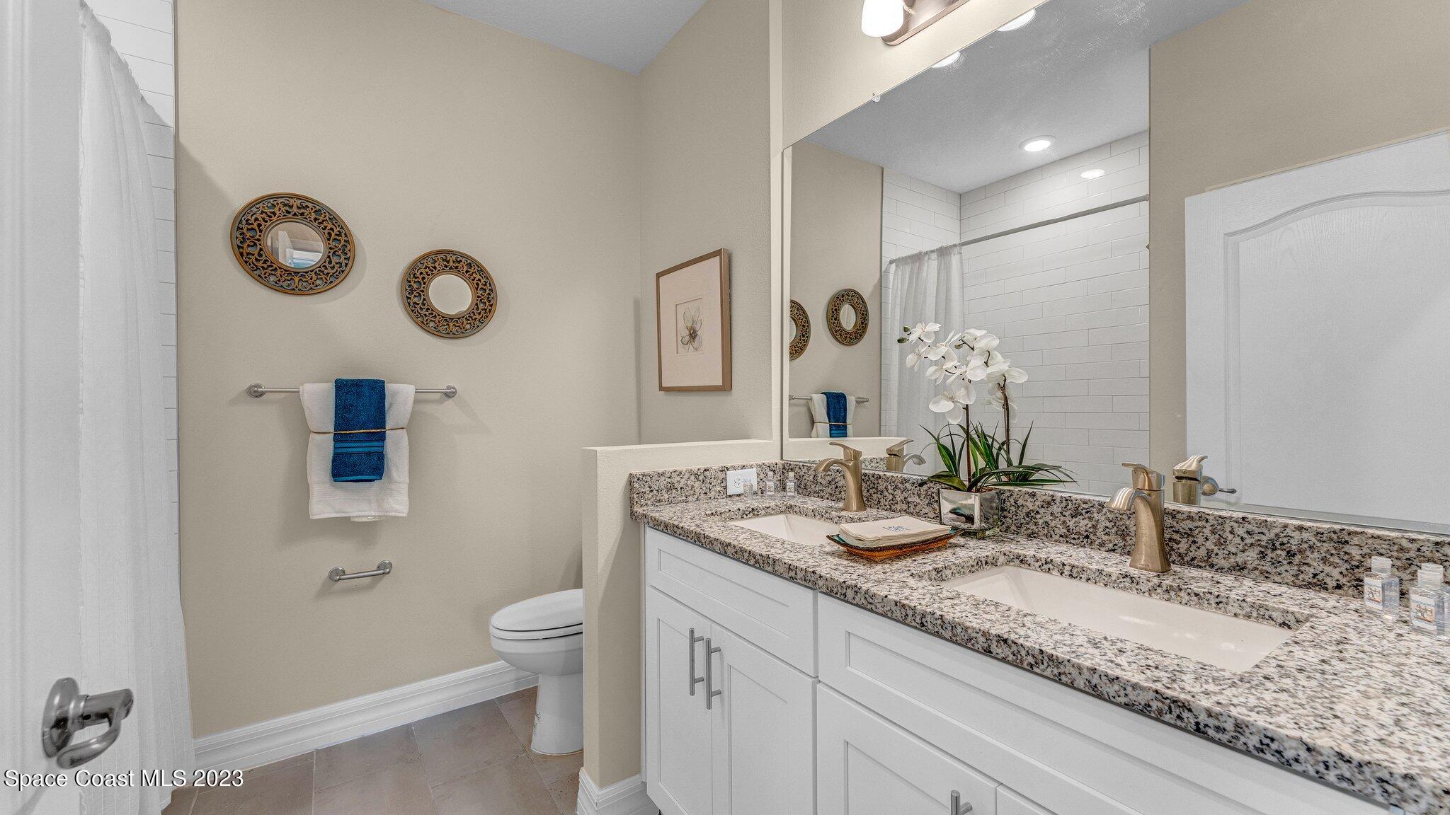 491 Tilhal Road Southwest Palm Bay, FL 32908 - Photo 22 of 30 a bathroom with a granite countertop sink and a mirror