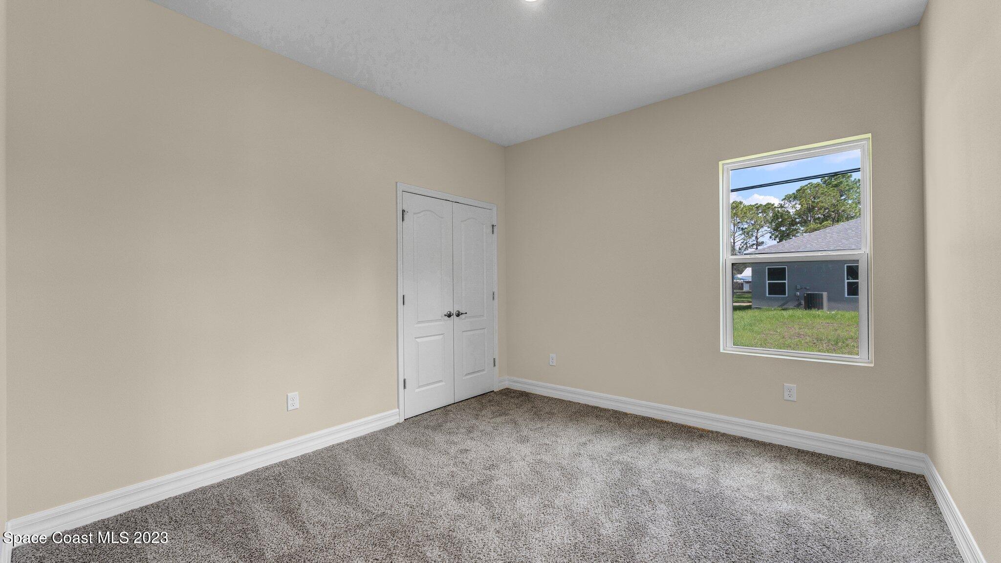 491 Tilhal Road Southwest Palm Bay, FL 32908 - Photo 23 of 30 an empty room with windows