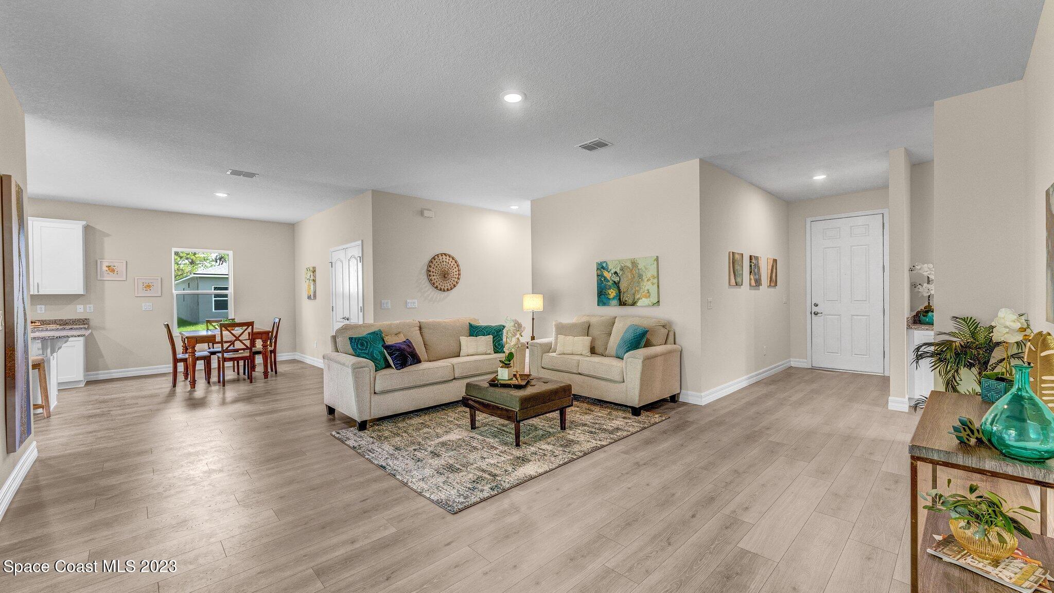 491 Tilhal Road Southwest Palm Bay, FL 32908 - Photo 4 of 30 a living room with furniture and wooden floor