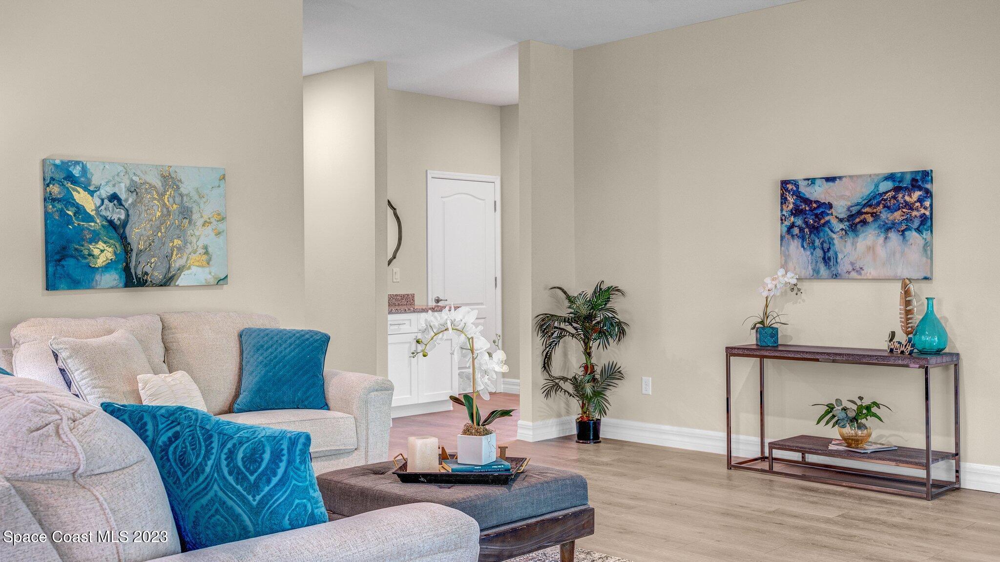 491 Tilhal Road Southwest Palm Bay, FL 32908 - Photo 6 of 30 a living room with furniture and wooden floor
