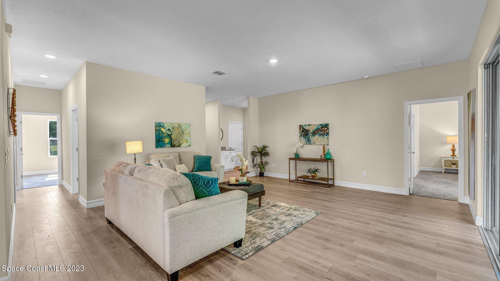 491 Tilhal Road Southwest Palm Bay, FL 32908 - Photo 7 of 30 a living room with furniture and wooden floor