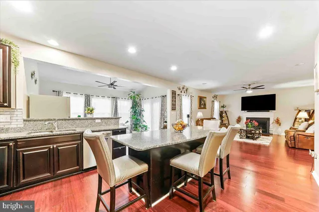 a living room with patio furniture and a potted plant