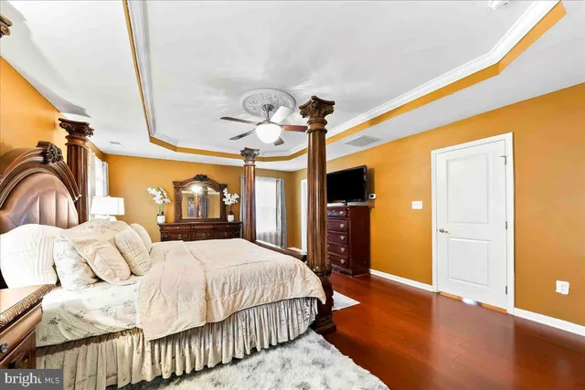 a bedroom with furniture and a flat screen tv
